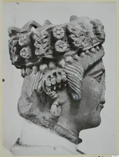 Cypro-Greek II limestone head from Arsos in profile, with a headdress of rosettes and leaves