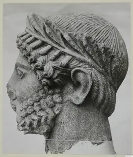 Limestone sculpture of a bearded head in profile, from Arsos