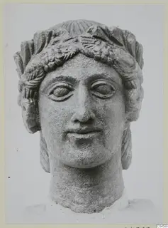 Limestone head of a woman wearing a leafy wreath, from Arsos