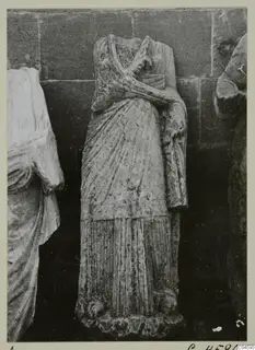 Headless draped standing statue from Arsos with one arm bent across the chest