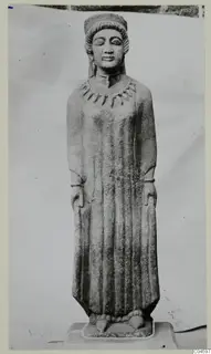 Limestone statue of a standing figure from Arsos, Cypro-Greek II, photographed against a pale backdrop