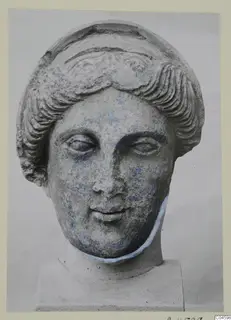 Stone head from Arsos with wavy hair and traces of blue colour on the face