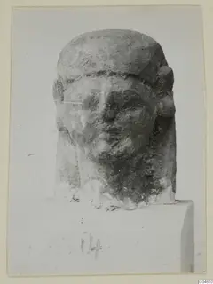 Limestone Neo-Cypriote head sculpture on a rectangular block base, shown from the front