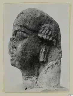 Limestone sculpture head, labelled Proto-Cypriote, shown in three-quarter view