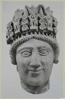 Limestone head sculpture from Arsos, with a tall headdress decorated with rosettes and small raised figures