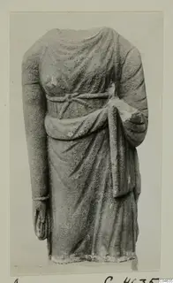 Headless stone statue of a draped standing figure from Arsos, shown from the front
