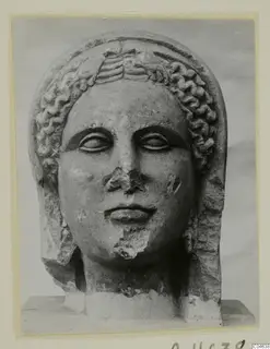 Stone statue head from Arsos, front view, with curled hair and a band across the brow.