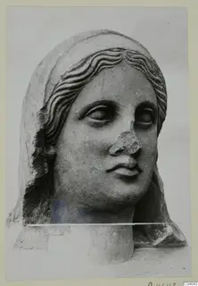 Stone statue head from Arsos, wearing a veil, with wavy hair and a broken nose