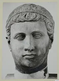 Stone statue head from Arsos, front view, with short wavy hair bound by a band