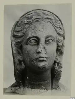 Stone head from Arsos with wavy hair in bands and a veil framing the face