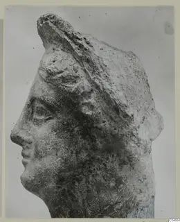 Stone head in left profile with a raised headdress, from Mersinaki