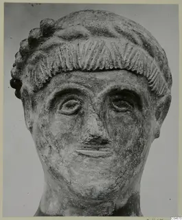 Head from Mersinaki, front view, with incised hair fringe and curled locks above the forehead