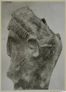 Limestone sculpture head from Mersinaki, with a ridged band over the hair and the ear visible in profile.
