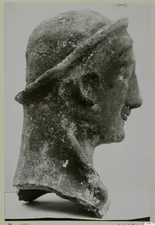Terracotta head of a figure in profile, wearing a band or veil over the head, from Mersinaki.