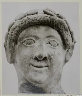 Terracotta head of a figure with a band of rounded curls around the forehead, from Mersinaki