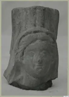 Small fragment of a moulded terracotta figure with a head in relief, from Soli.