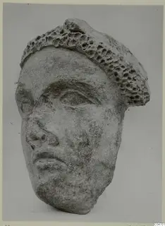 Stone head from Mersinaki with heavy brows, almond eyes and a pitted, honeycomb-textured top