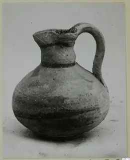 Pottery Bichrome V jug with a single loop handle and dark painted bands on the neck and body