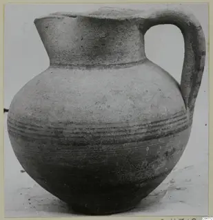 Pottery jug with a high loop handle and bands of dark painted lines around the body, from Amathus.