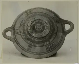 Pottery Bichrome III vessel with two loop handles, seen from above, with dark painted concentric rings and hatched panels