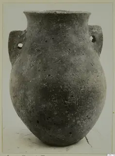 Pottery jar with a flared rim and two handles, each pierced by a hole