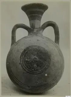 Pottery Bichrome III vessel from Amathus with a round body, flaring neck and two loop handles