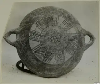 Pottery Black Slip Bichrome vessel with two loop handles, decorated with pale concentric circles and radiating bands