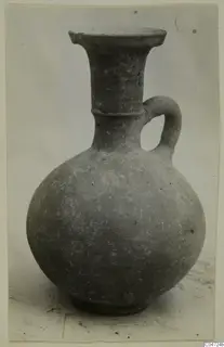 Grey-brown jug with a flared rim, a single strap handle and a ring base, from Amathus.