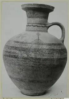 Pottery Bichrome III jug with a flaring neck, single handle and painted bands and linear motifs on the body