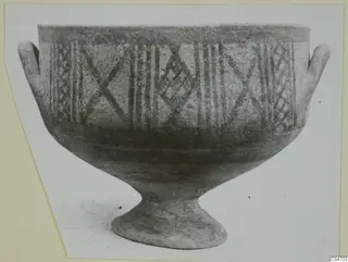 Pottery White Painted II bowl from Amathus, footed, with two small handles and painted cross and lattice bands