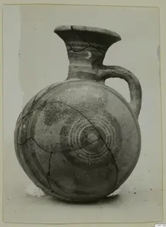 Pottery White Painted II jug from Amathus with a round body, painted concentric circles and visible cracks