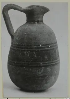 Pottery Bichrome III jug from Amathus, with a single loop handle and dark horizontal bands on the body