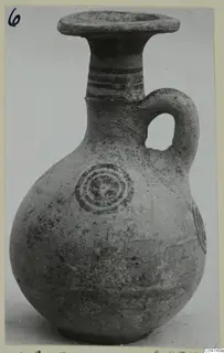 Jug from Amathus with a flared rim, loop handle, dark painted bands and concentric circles on the body