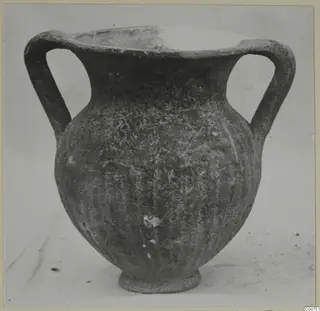 Two-handled Black Slip I-VI vessel from Amathus, photographed on a pale background