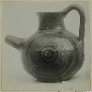 Pottery White Painted IV jug with side spout and strap handle, dark painted spirals on the body