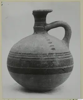 Jug of Pottery Bichrome IV type from Amathus, with dark painted bands around the body and a single loop handle