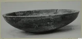 Wide, shallow pottery bowl from Amathus with a rounded body and rim, photographed at an angle on a pale background.