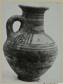 Pottery Bichrome III jug with a loop handle, dark painted bands and a hatched pattern on the shoulder