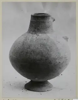 Plain white pottery vessel with a rounded body, narrow neck and small lug handles, from Amathus