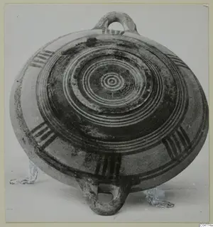 Pottery Bichrome III, a flat round vessel with concentric painted rings and two loop handles