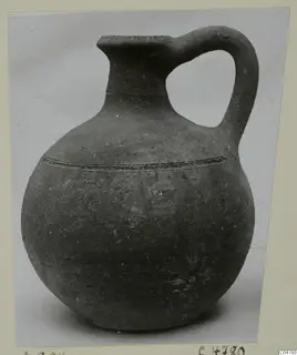 Pottery jug with one handle, globular body and a raised ridged band around the shoulder, from Amathus tombs