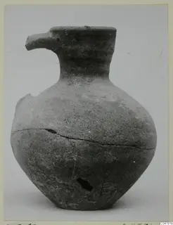 Pottery Plain White IV-V vessel from Amathus with a spout-like lip, narrow neck and globular body, cracked and chipped.
