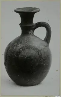 Pottery jug with a single loop handle and concentric circle decoration in dark paint, from Amathus tombs 1–9.