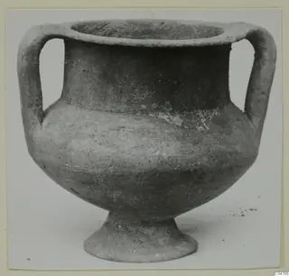 Two-handled grey polished pottery vessel on a pedestal foot, from Amathus