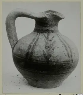 Pottery jug from Amathus with a strap handle, pinched spout and dark painted bands and strokes on the body