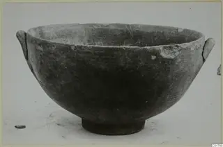 Pottery bowl with two small handles and a ring foot, recorded as Pottery Black-on-Red I-III
