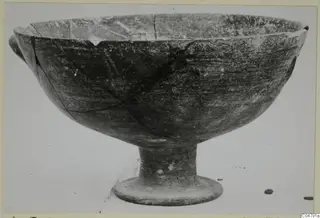 Footed pottery bowl with a chipped rim and a small handle stub, from Amathus, Pottery Black-on-Red I-III