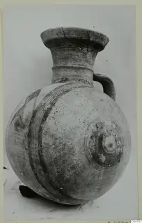 Pottery Bichrome I vessel from Amathus: round-bodied jug with dark painted bands and a loop handle.