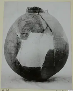 Globular jug reconstructed from sherds, with faint painted decoration on the upper body