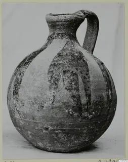 Round-bodied jug with a tall neck, loop handle and dark painted vertical bands, photographed on a plain background.